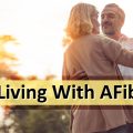 Managing afib symptoms. Senior couple dancing outdoors.