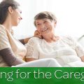 Caring for the caregiver. Caregiver and patient smiling while sitting on the sofa.